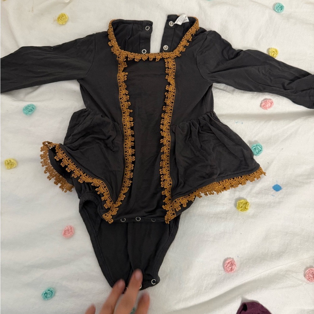 Kate Quinn black and gold bodysuit